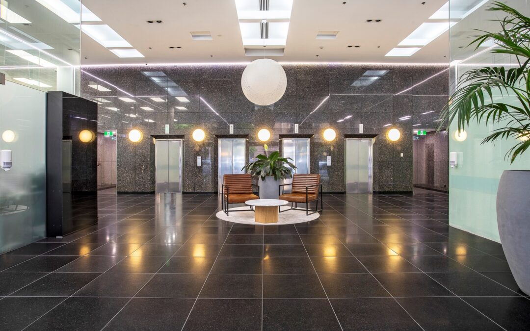 Foyer of 30 Currie Street, with waiting area and elevators in the space.