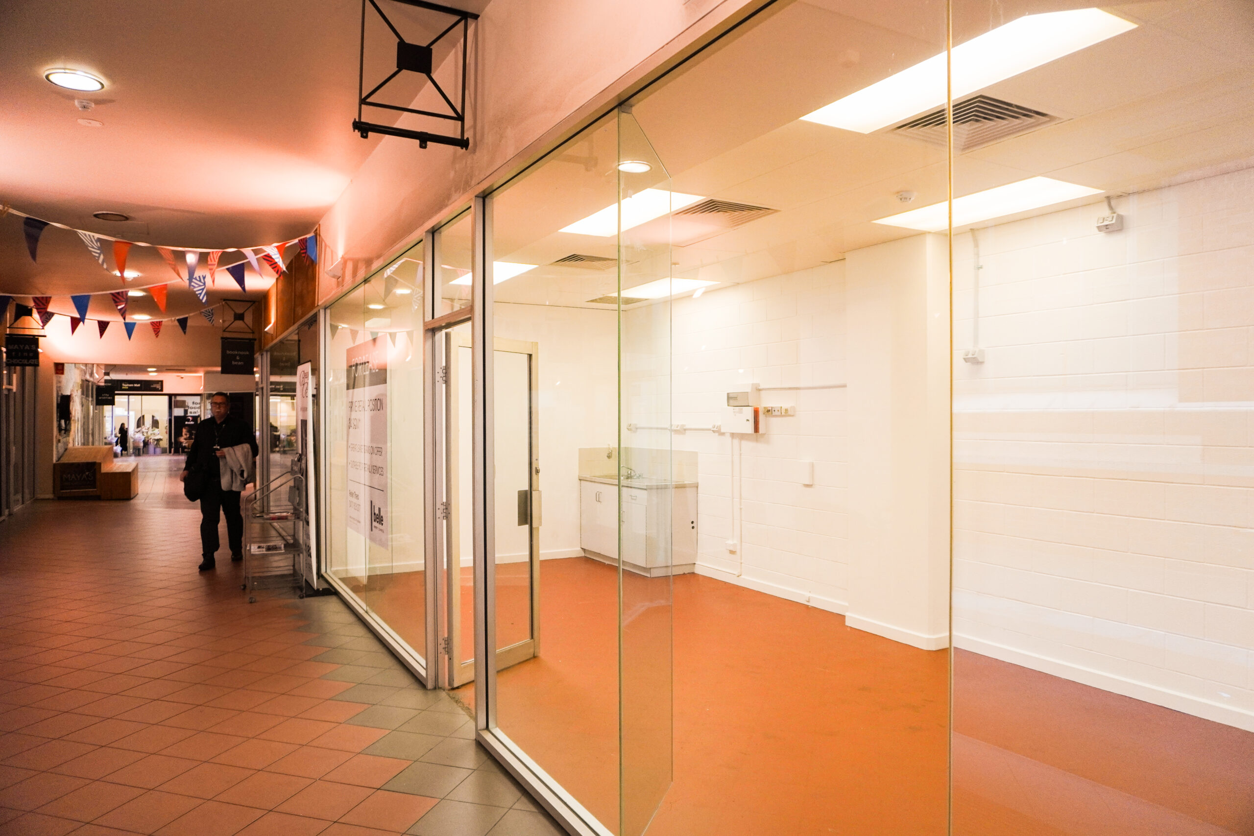 View from outside Shop 17 showing large glass frontage and mall walkway.