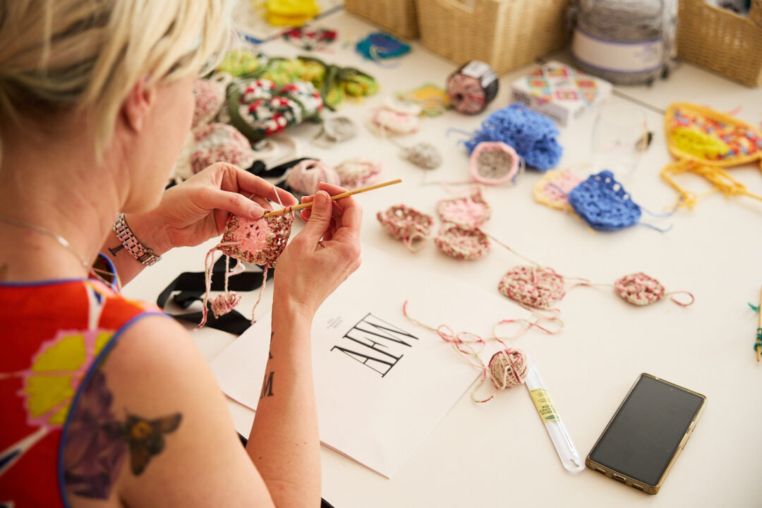 someone crocheting with a crochet hook and yarn