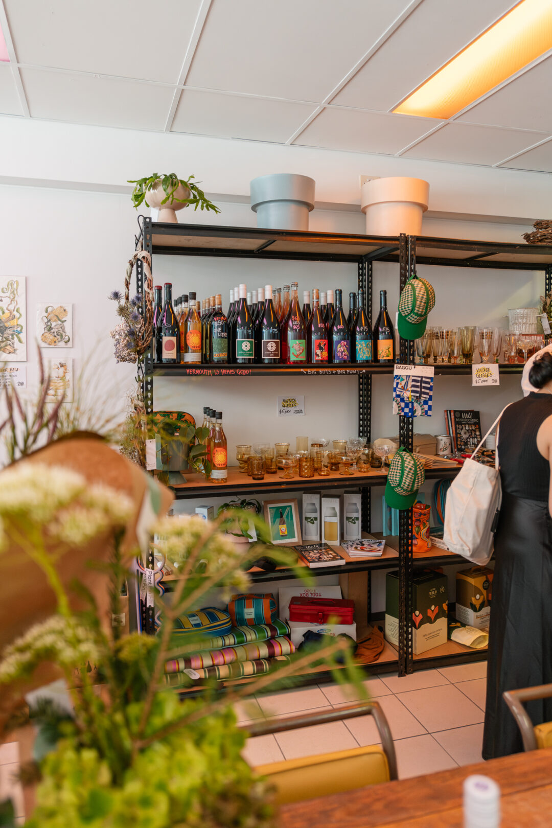 shelves with wine bottles and a selection of retail objects