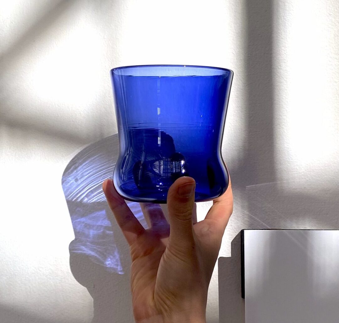 hand holding a blue glass