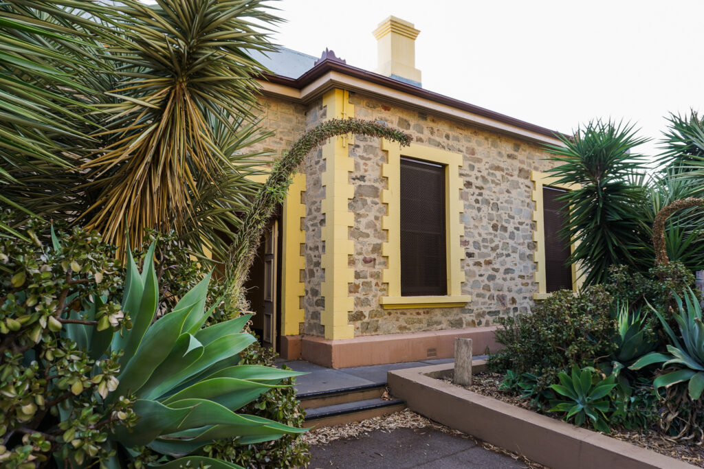 nars-exterior Exterior of North Adelaide Railway Station, showing stonework, yellow painted door frames and lots of succulents.