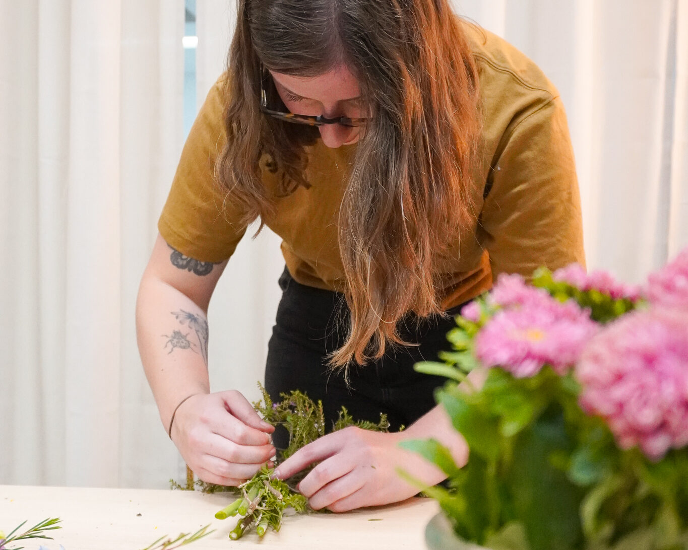 flowerbug Flowerbug owner Brooke tying a bunch of pink flowers.