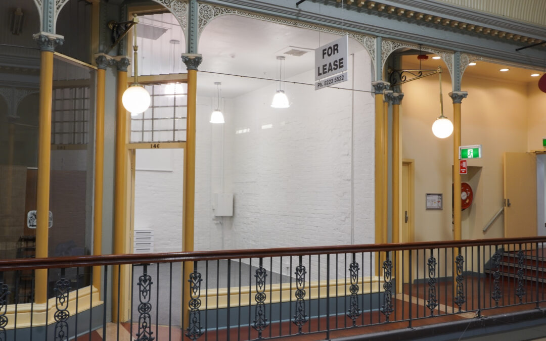 Brightly lit room with white walls and a balcony in front of it.