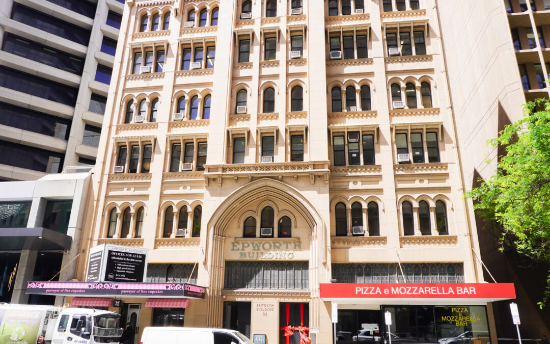 Exterior of Epworth Building, with Gothic style architecture and eateries on the ground level.