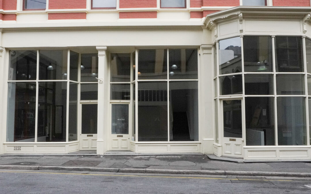 Eye level view of window frontage to empty storefront.