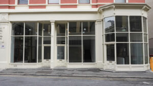 Eye level view of window frontage to empty storefront.