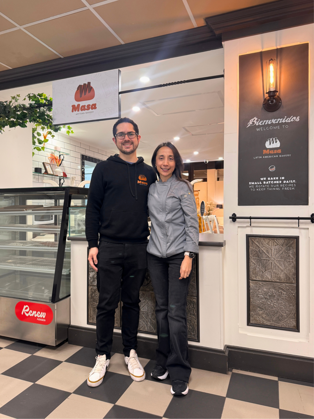 Founders of Masa Bakery, Camilo and Diana in front of their cafe.